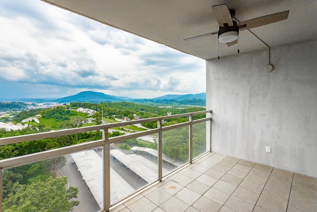 balcony featuring ceiling fan and a mountain view