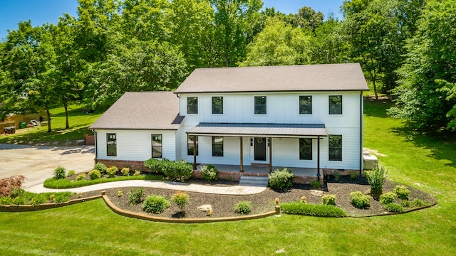 modern farmhouse style home featuring a front lawn and a porch