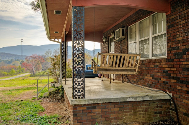 view of patio featuring a mountain view and an AC wall unit