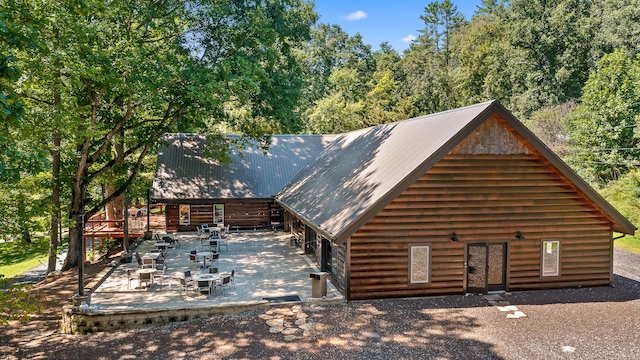 log home featuring a patio