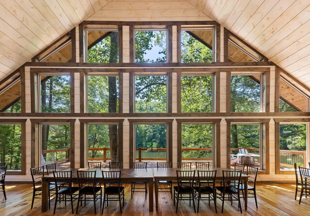 dining space featuring lofted ceiling and hardwood / wood-style flooring