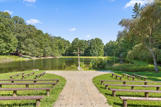 view of property's community featuring a water view and a lawn