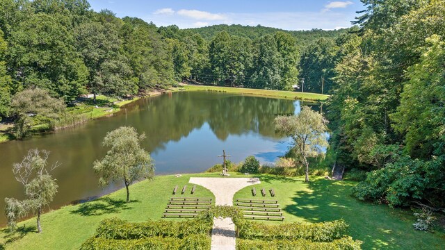 exterior space with a water view and a lawn