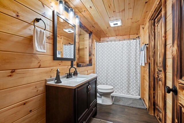 bathroom featuring vanity, toilet, hardwood / wood-style floors, and walk in shower