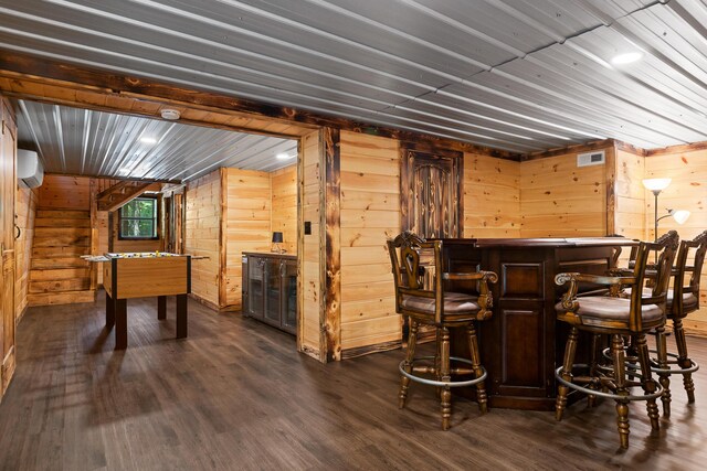 bar featuring wood walls, dark hardwood / wood-style flooring, and a wall mounted air conditioner