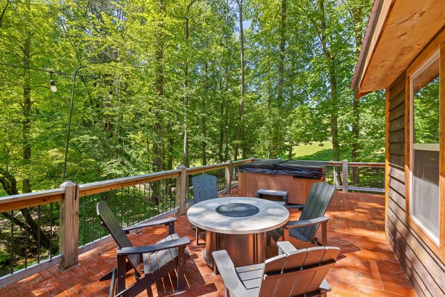 wooden terrace with a hot tub