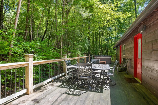 wooden deck with a hot tub