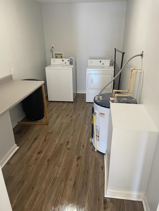 laundry area with dark wood-type flooring and independent washer and dryer