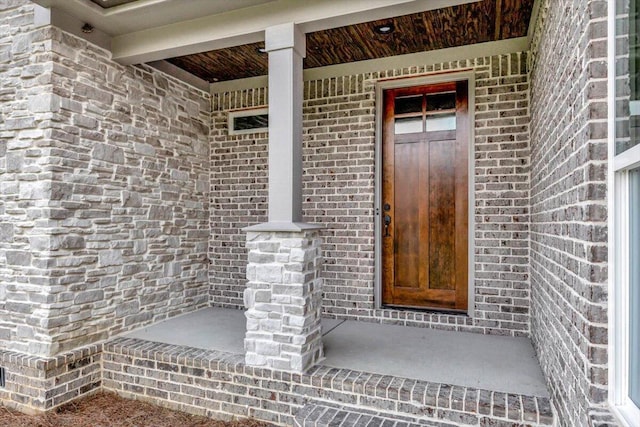 property entrance featuring brick siding