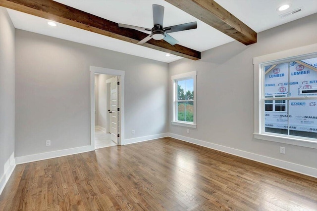 unfurnished room featuring hardwood / wood-style floors, ceiling fan, and beam ceiling