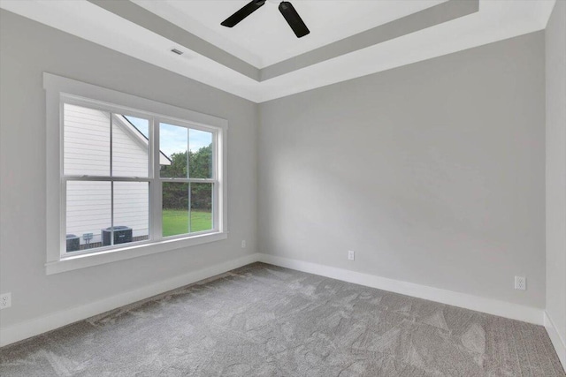 unfurnished room featuring carpet, ceiling fan, and a tray ceiling