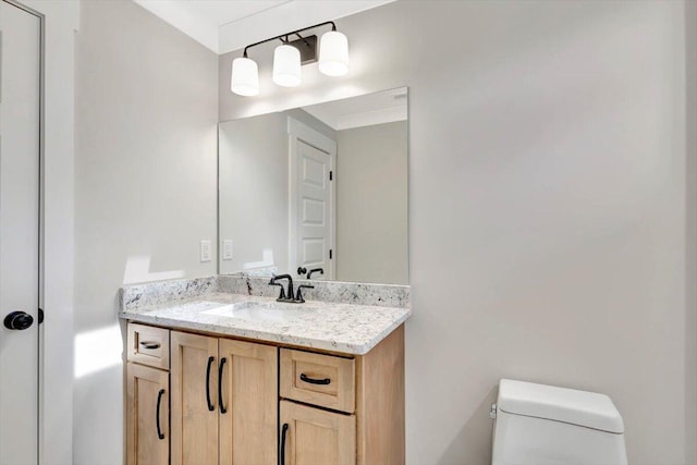 bathroom with toilet and vanity