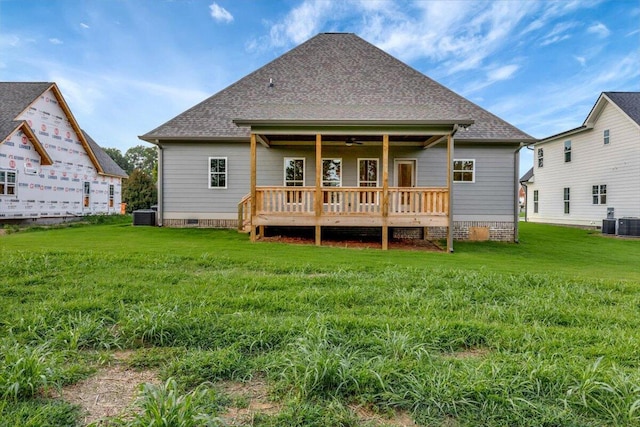 back of property featuring a yard, ceiling fan, and central air condition unit