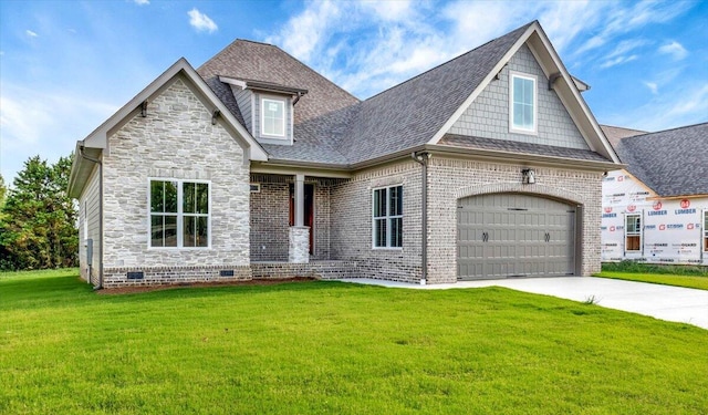 view of front of house featuring a garage and a front lawn