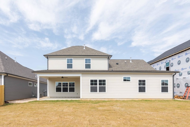 back of property featuring ceiling fan, a yard, and a patio