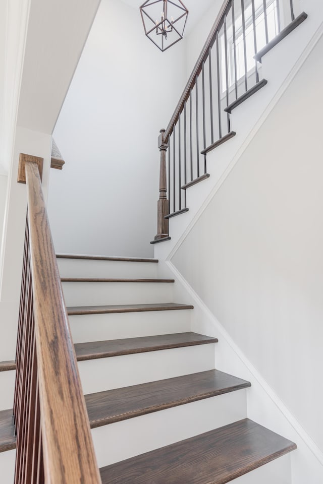 staircase featuring a chandelier