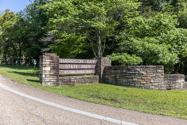 community / neighborhood sign with a lawn