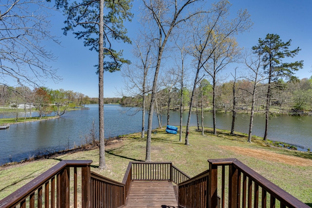 wooden terrace with a water view and a lawn