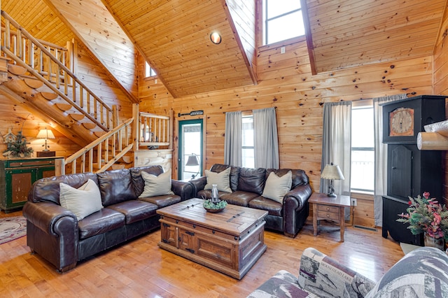 living room featuring wood-type flooring, a healthy amount of sunlight, and a skylight