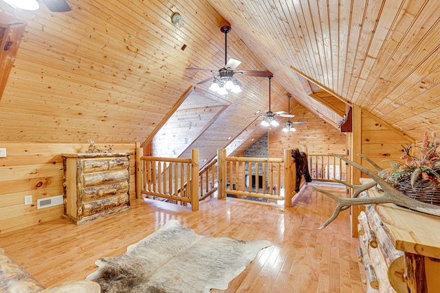 bedroom with wooden ceiling, lofted ceiling, hardwood / wood-style floors, and wooden walls