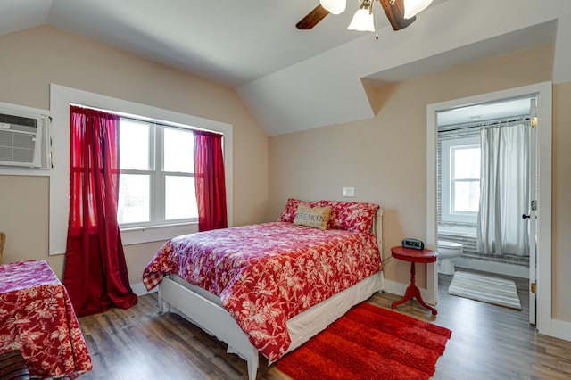 bedroom with lofted ceiling, hardwood / wood-style flooring, ceiling fan, and multiple windows