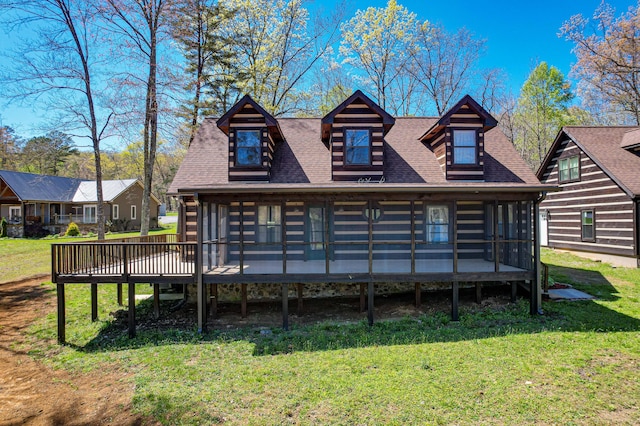 back of property with a lawn and a wooden deck