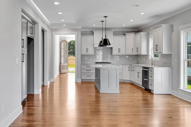 kitchen with a center island, light wood-type flooring, and white cabinetry