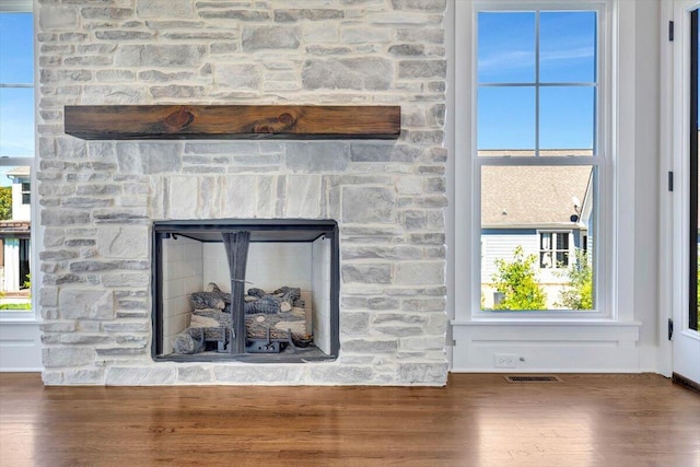 room details with a fireplace and wood-type flooring