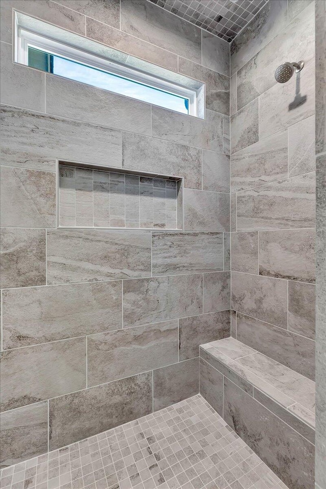 bathroom with a tile shower