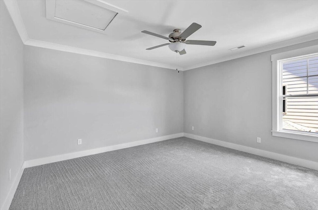 empty room with ornamental molding, ceiling fan, and carpet flooring