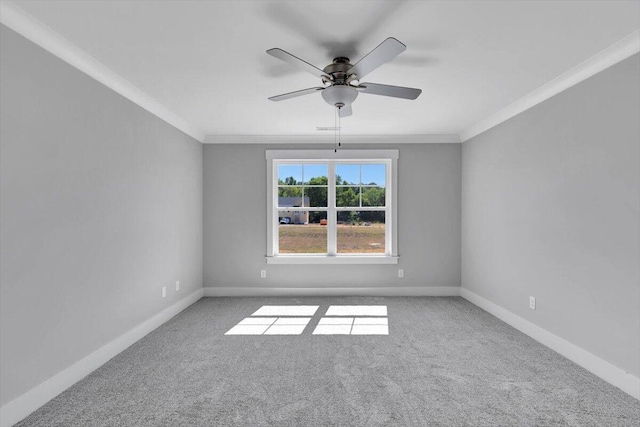 unfurnished room with ceiling fan, baseboards, ornamental molding, and carpet flooring