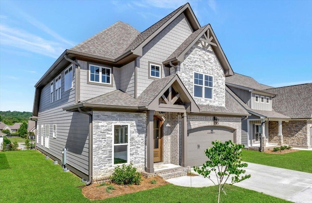 craftsman-style house featuring stone siding, driveway, a shingled roof, and a front lawn