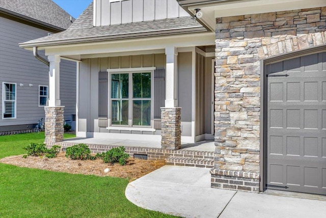 entrance to property with roof with shingles, a porch, stone siding, crawl space, and board and batten siding