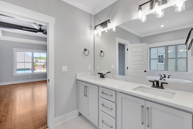 bathroom featuring vanity, ceiling fan, ornamental molding, and hardwood / wood-style floors