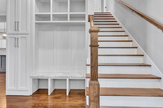 staircase with wood-type flooring