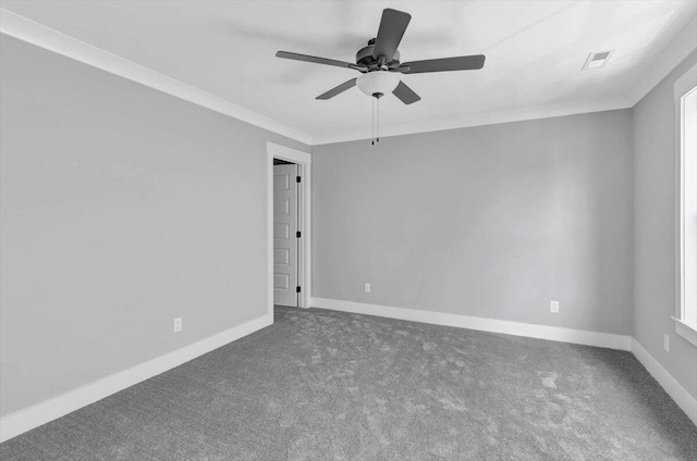 spare room with visible vents, carpet floors, baseboards, and crown molding