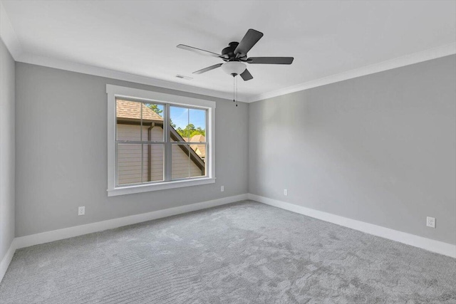 spare room with carpet flooring, ceiling fan, and ornamental molding