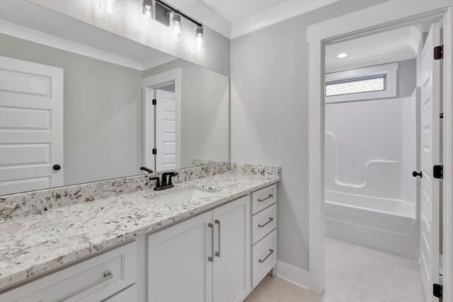 full bath featuring vanity, baseboards, and ornamental molding