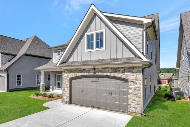 view of front of property featuring a front yard, concrete driveway, and board and batten siding