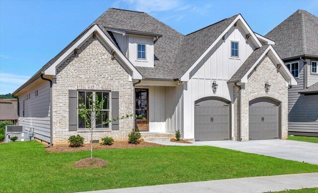 view of front of home with brick siding, board and batten siding, driveway, and a front lawn