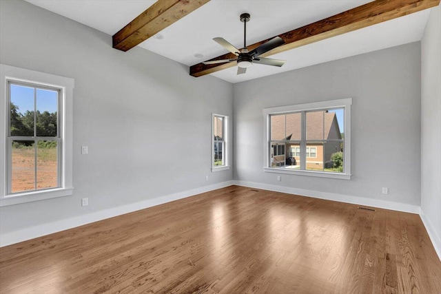 spare room with beam ceiling, hardwood / wood-style flooring, and ceiling fan