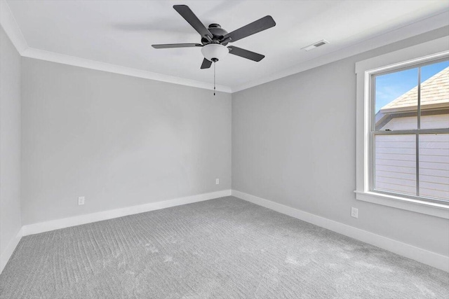 spare room featuring crown molding, carpet, and ceiling fan