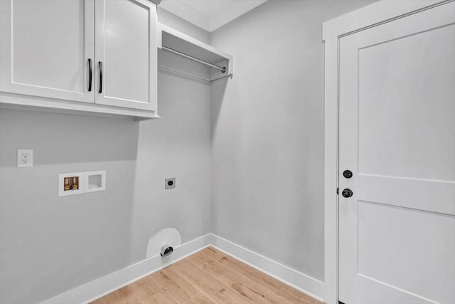 laundry area featuring hookup for an electric dryer, light hardwood / wood-style flooring, washer hookup, and cabinets