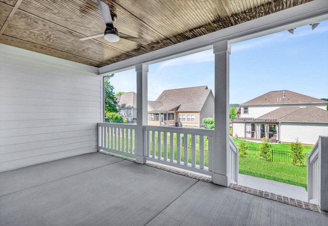 view of patio / terrace with fence, a residential view, and ceiling fan