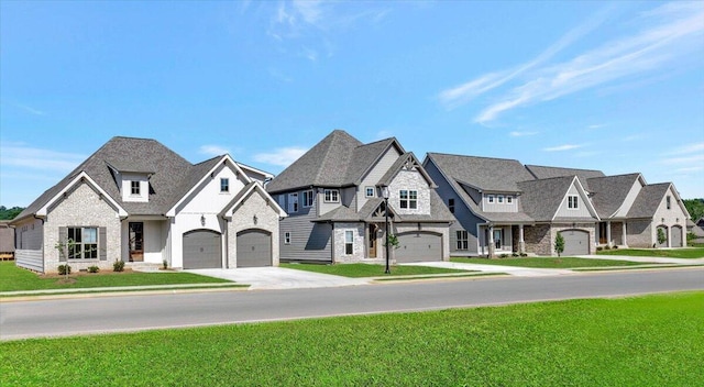 french provincial home with a front yard and a garage