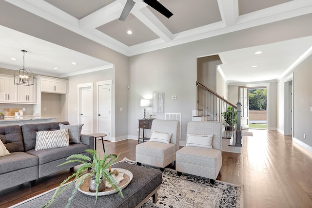 living room featuring crown molding, coffered ceiling, wood-type flooring, and ceiling fan