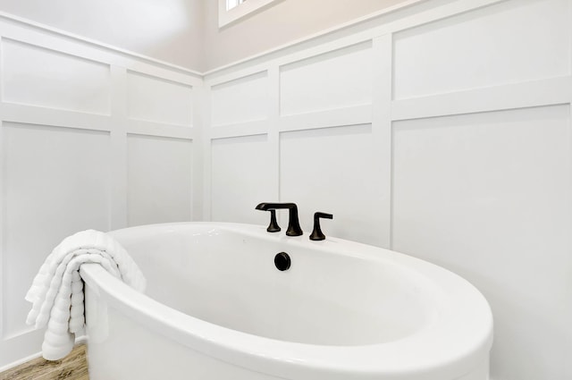 bathroom featuring hardwood / wood-style flooring and a bathtub