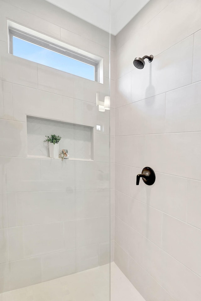 bathroom with tiled shower