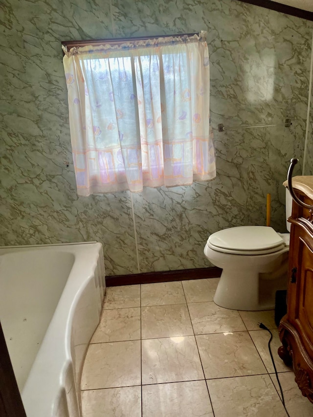 bathroom featuring tile patterned flooring, a tub, and toilet