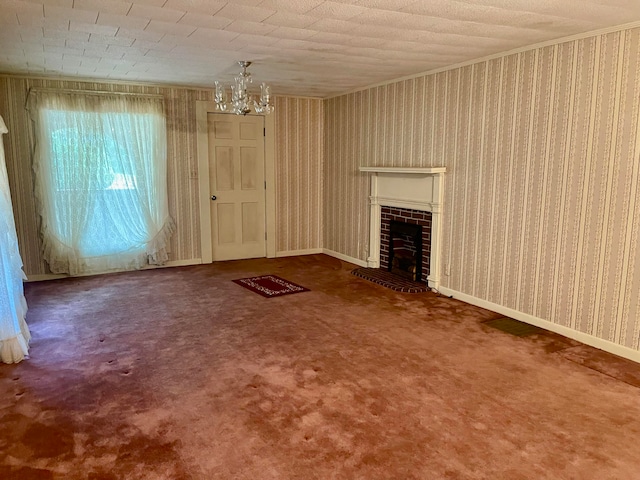 unfurnished living room featuring a brick fireplace, an inviting chandelier, and carpet floors